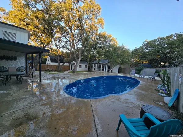 a view of a swimming pool with a patio