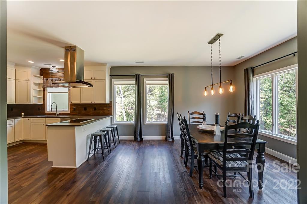 2670 Island View Circle Fort Mill, SC 29708 - Photo 17 of 48 a kitchen with stainless steel appliances a dining table chairs stove a refrigerator and wooden floor