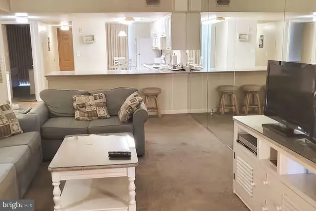 a kitchen with a white cabinets and chairs