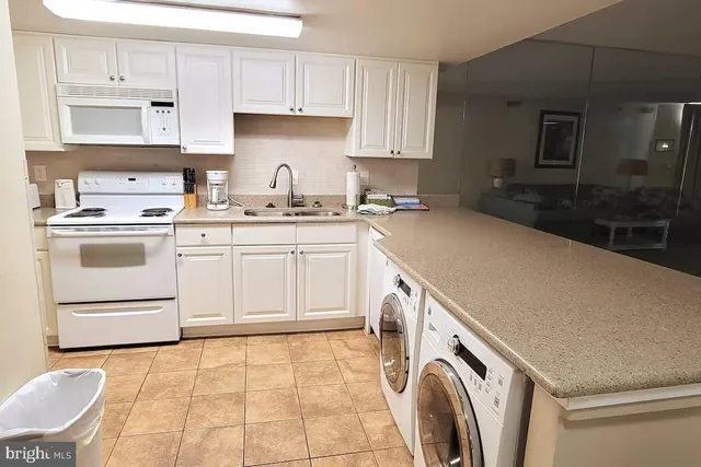 a kitchen with a sink a stove and cabinets