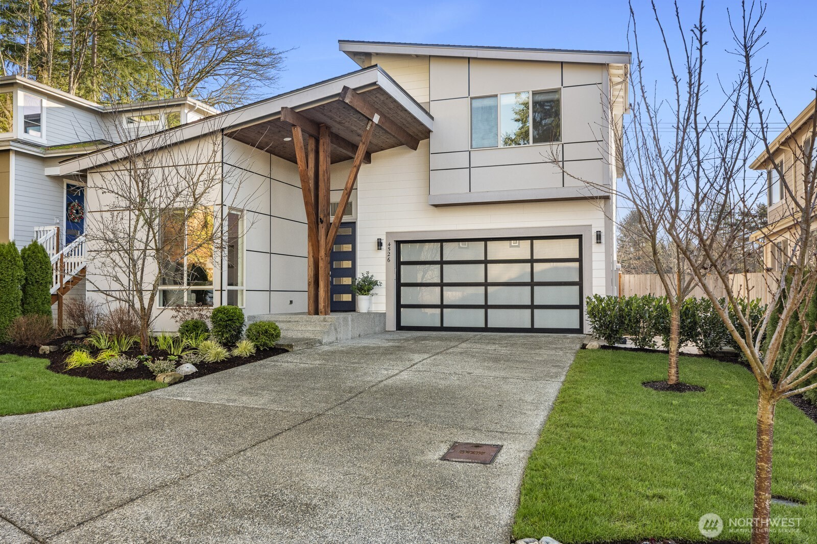 4526 327th Place Northeast Carnation, WA 98014 - Photo 33 of 36 a front view of a house with a yard and potted plants