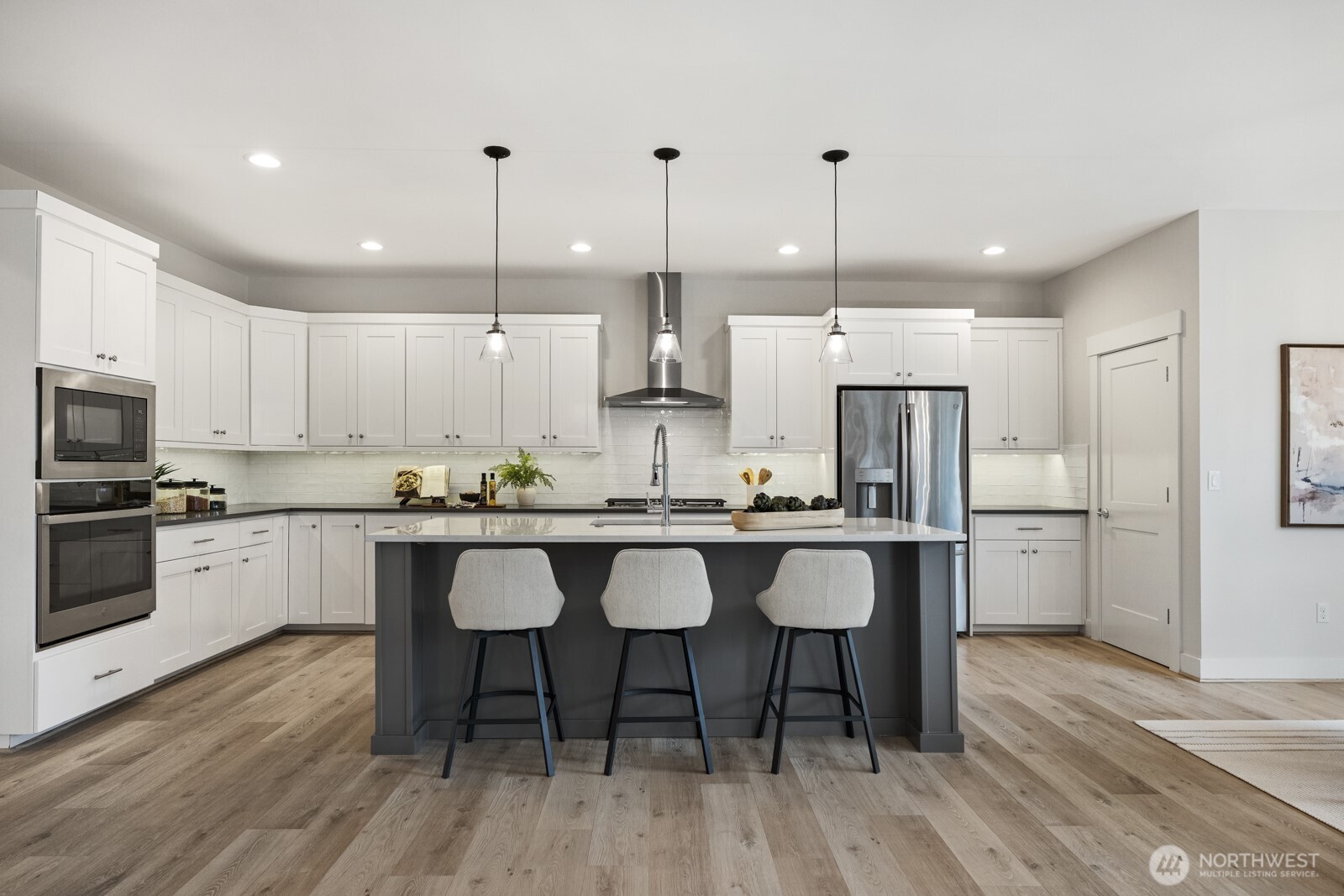 4526 327th Place Northeast Carnation, WA 98014 - Photo 5 of 36 a kitchen with stainless steel appliances granite countertop a sink a stove a refrigerator and island with wooden floor