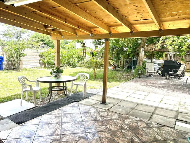 a view of a chairs and table in the patio