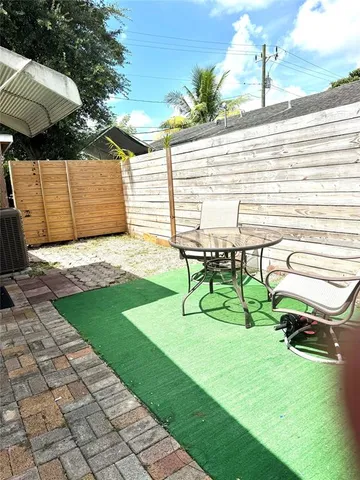 a view of backyard with a table and chairs