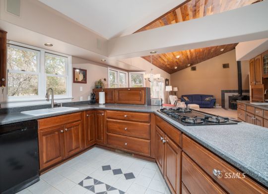 3835 West Ridgecrest Boulevard Ridgecrest, CA 93555 - Photo 19 of 50 a kitchen with stainless steel appliances granite countertop a stove a sink and a microwave