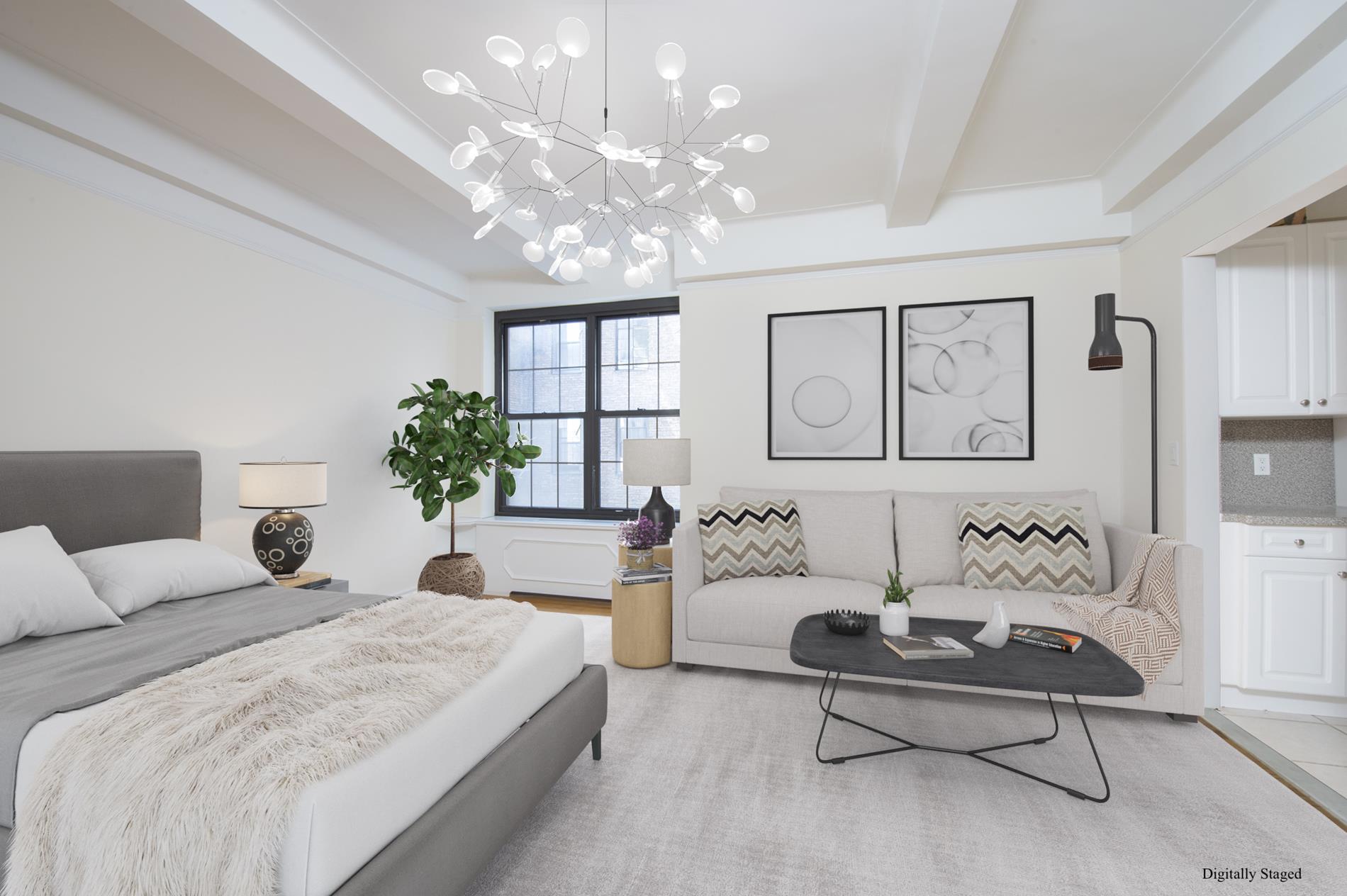 a spacious bedroom with a bed and a chandelier