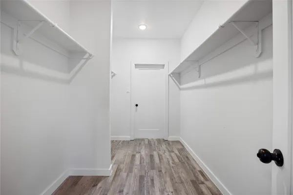 a view of a room with wooden floor