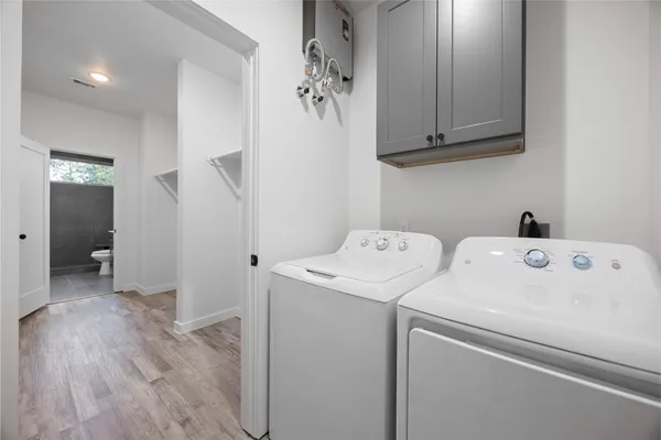 a view of storage and utility room with washer and dryer