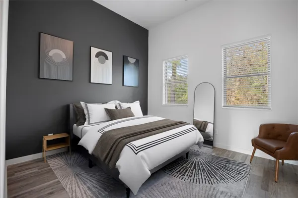 a bedroom with bed and a window