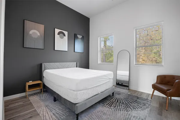 a bed room with a bed and a chair