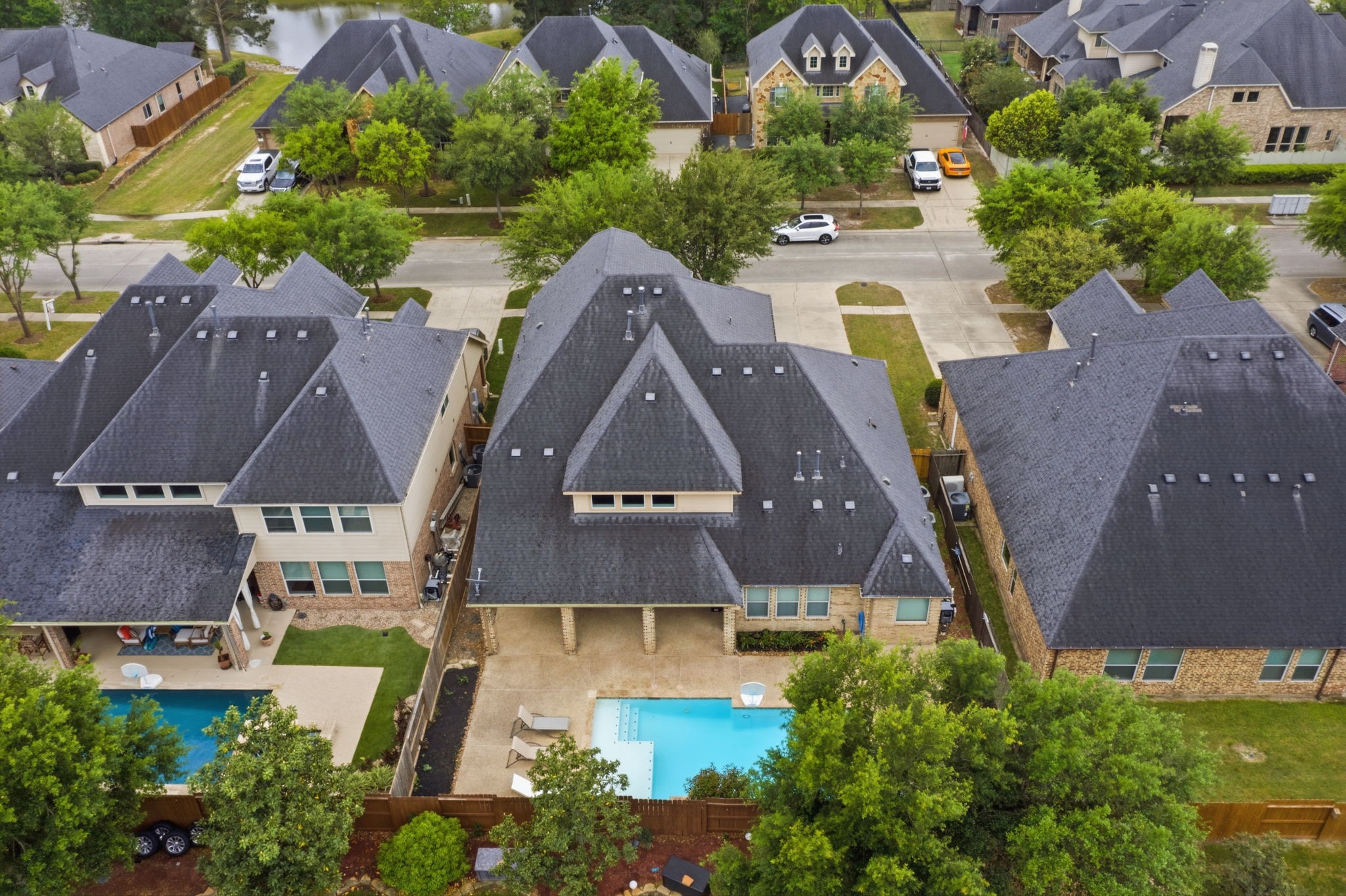 8169 Tranquil Lake Way Conroe, TX 77385 - Photo 20 of 26 an aerial view of a house with swimming pool and outdoor seating