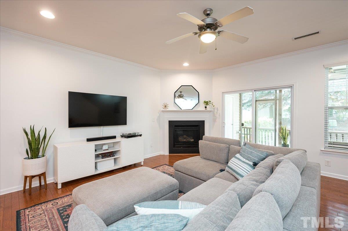2405 Swans Rest Way Raleigh, NC 27606 - Photo 11 of 29 a living room with furniture a flat screen tv and a fireplace