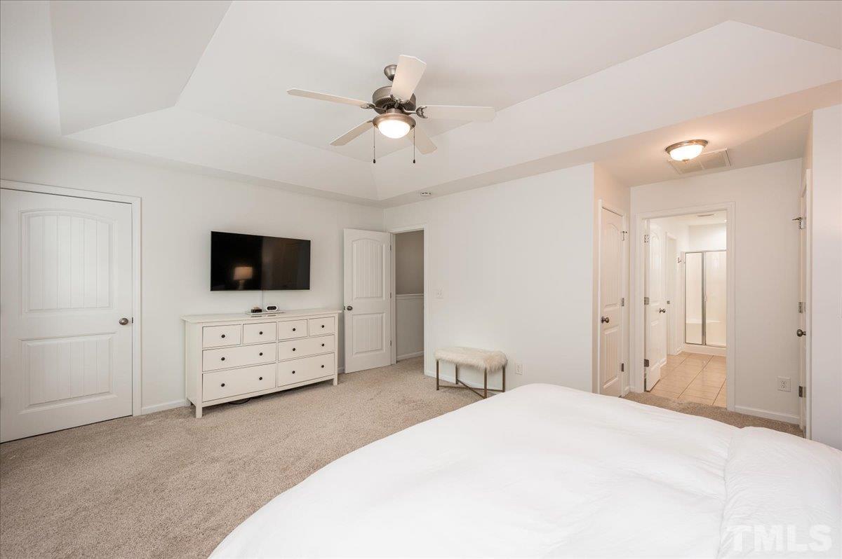 2405 Swans Rest Way Raleigh, NC 27606 - Photo 17 of 29 a bedroom with a bed and a flat screen tv