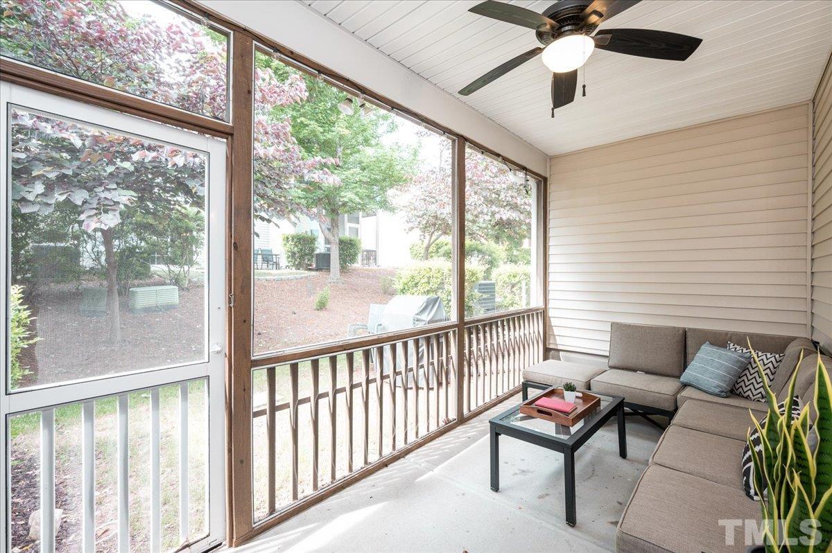 2405 Swans Rest Way Raleigh, NC 27606 - Photo 23 of 29 a living room with furniture and a floor to ceiling window