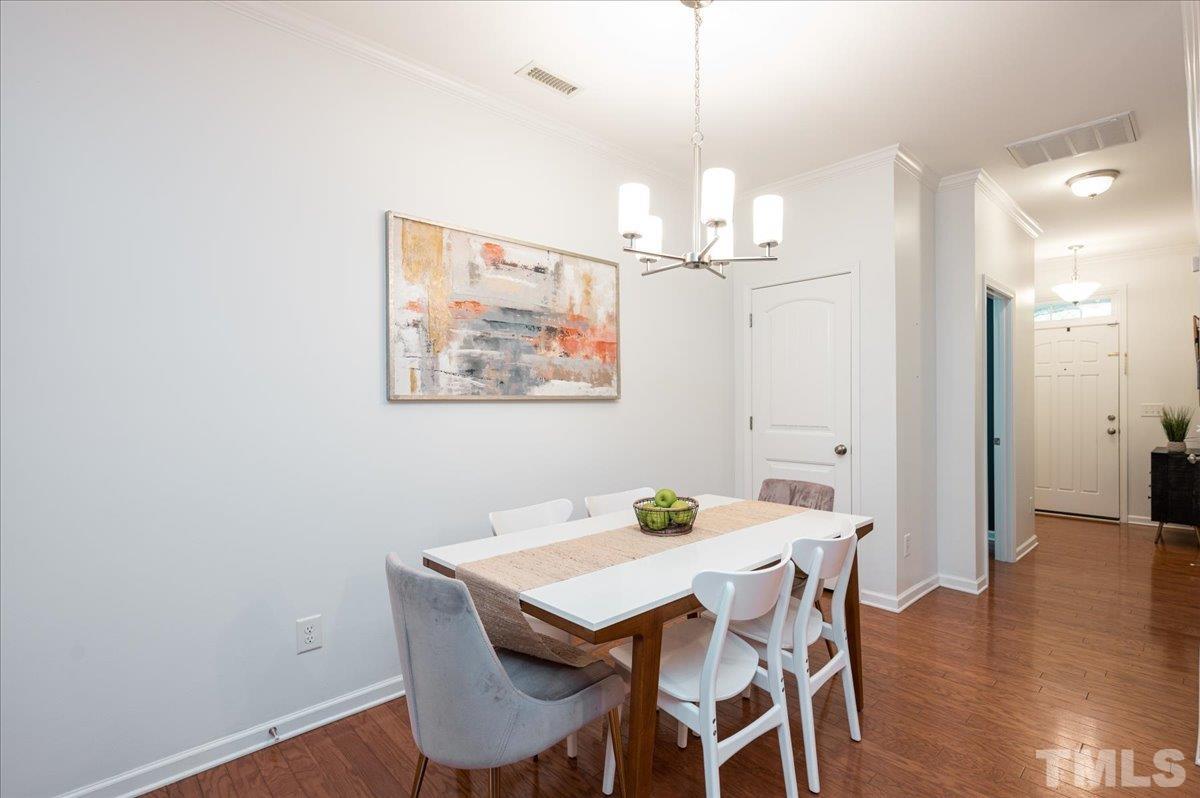 2405 Swans Rest Way Raleigh, NC 27606 - Photo 6 of 29 a view of a dining room with furniture and wooden floor