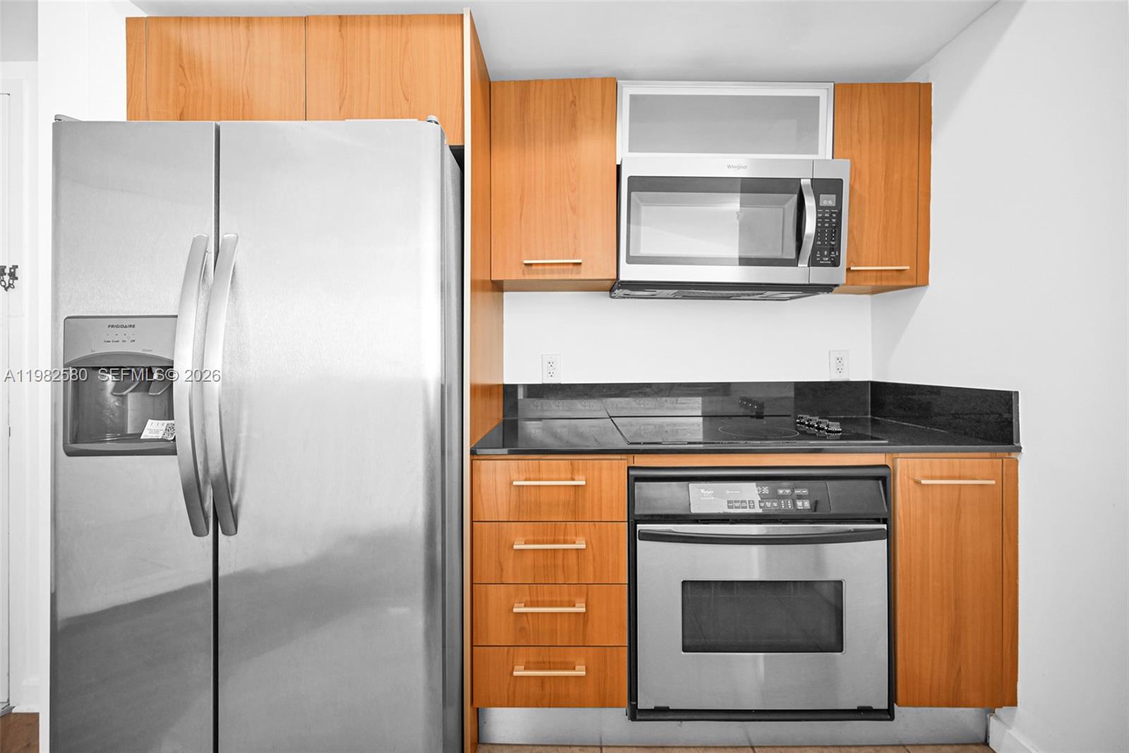 9055 Southwest 73rd Court, Unit 1104 Miami, FL 33156 - Photo 11 of 19 a stove top oven sitting inside of a kitchen