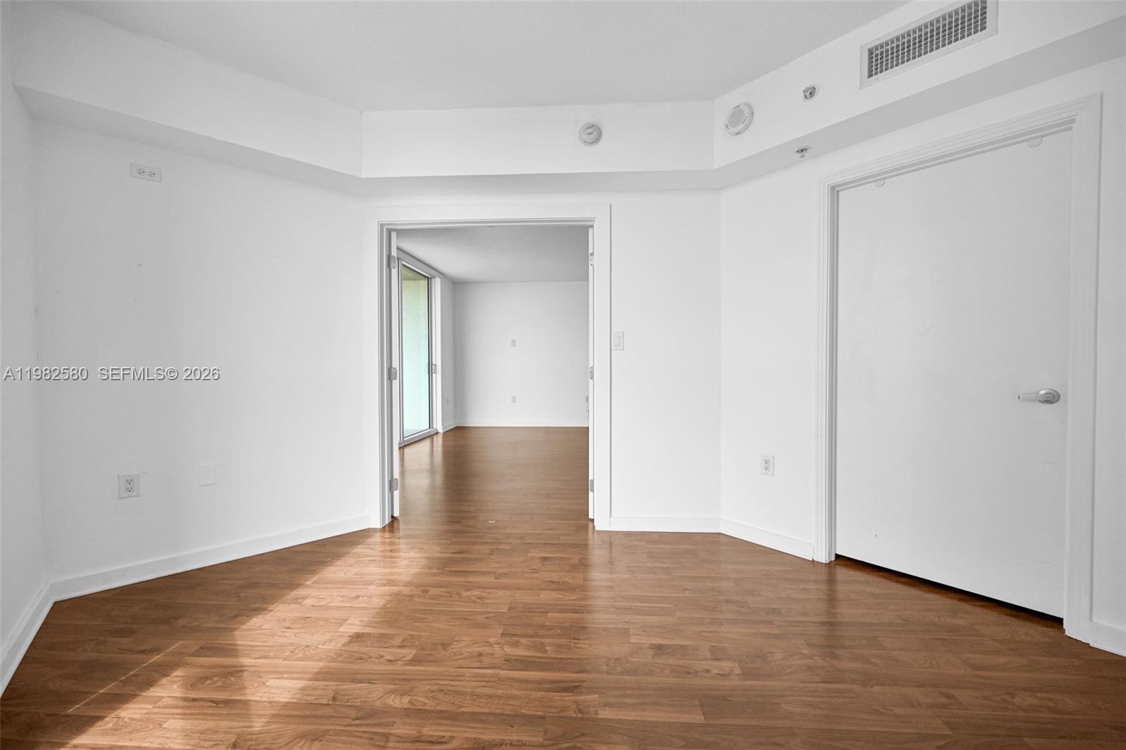 9055 Southwest 73rd Court, Unit 1104 Miami, FL 33156 - Photo 13 of 19 a view of empty room with wooden floor
