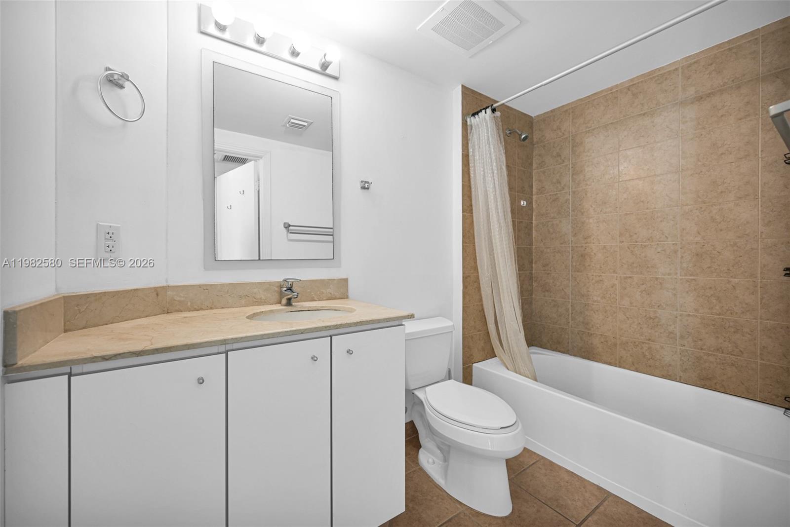 9055 Southwest 73rd Court, Unit 1104 Miami, FL 33156 - Photo 14 of 19 a bathroom with a granite countertop sink toilet and shower