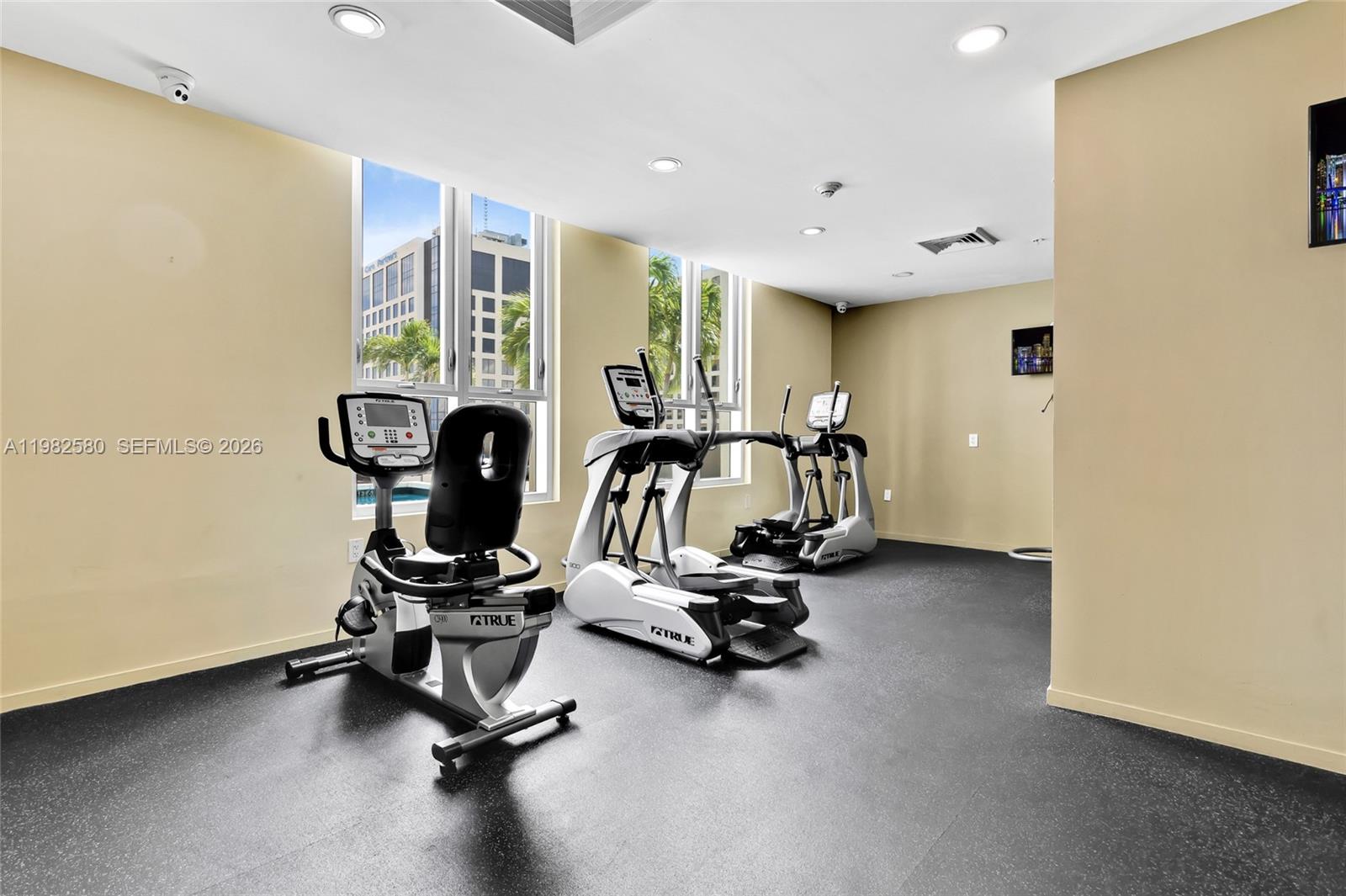 9055 Southwest 73rd Court, Unit 1104 Miami, FL 33156 - Photo 18 of 19 a view of a room with gym equipment