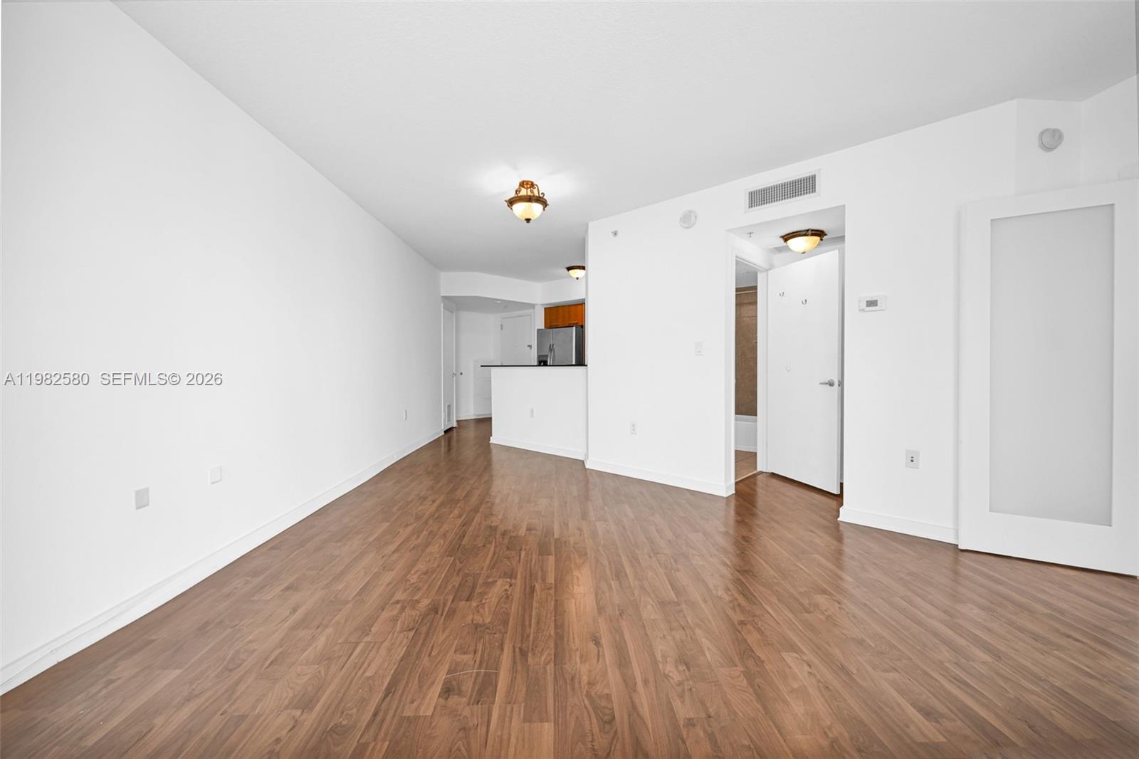 9055 Southwest 73rd Court, Unit 1104 Miami, FL 33156 - Photo 6 of 19 a view of empty room with wooden floor