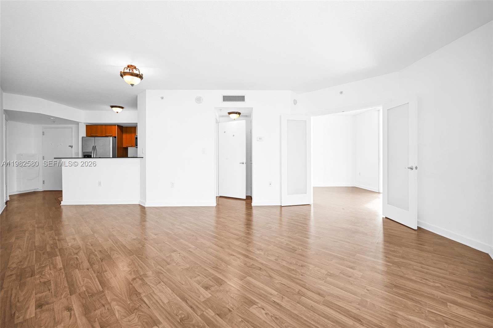 9055 Southwest 73rd Court, Unit 1104 Miami, FL 33156 - Photo 7 of 19 a view of a kitchen with wooden floor and a refrigerator