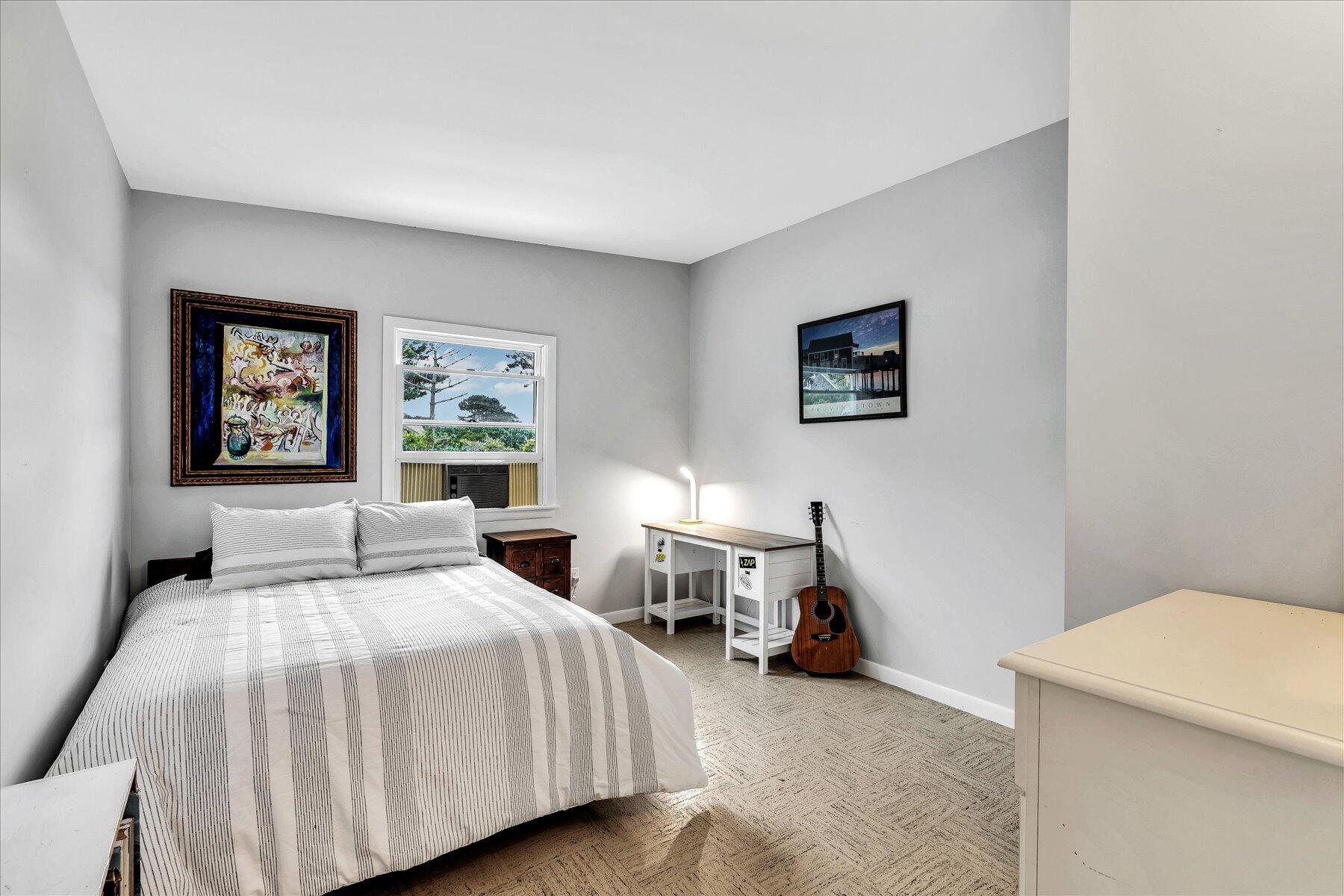 60 5th Avenue Wellfleet, MA 02667 - Photo 19 of 42 a bedroom with a bed and a lamp