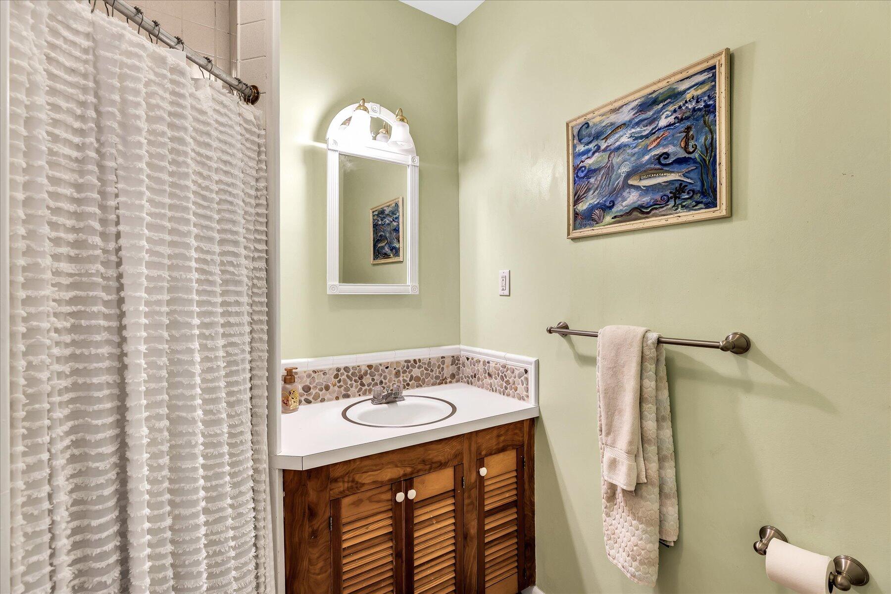 60 5th Avenue Wellfleet, MA 02667 - Photo 22 of 42 a bathroom with a sink a mirror and a shower
