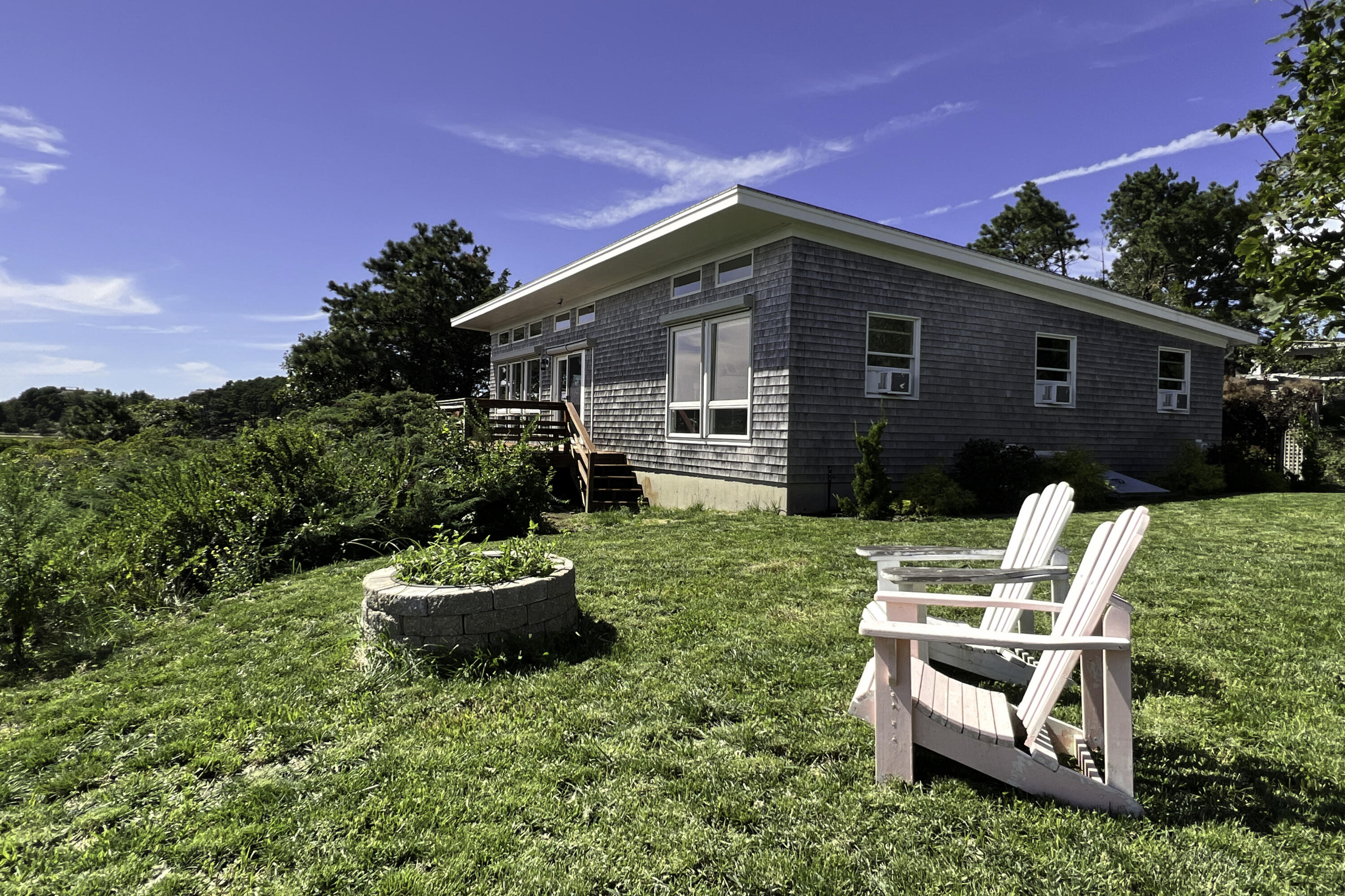 60 5th Avenue Wellfleet, MA 02667 - Photo 36 of 42 a backyard of a house with a garden and barbeque oven