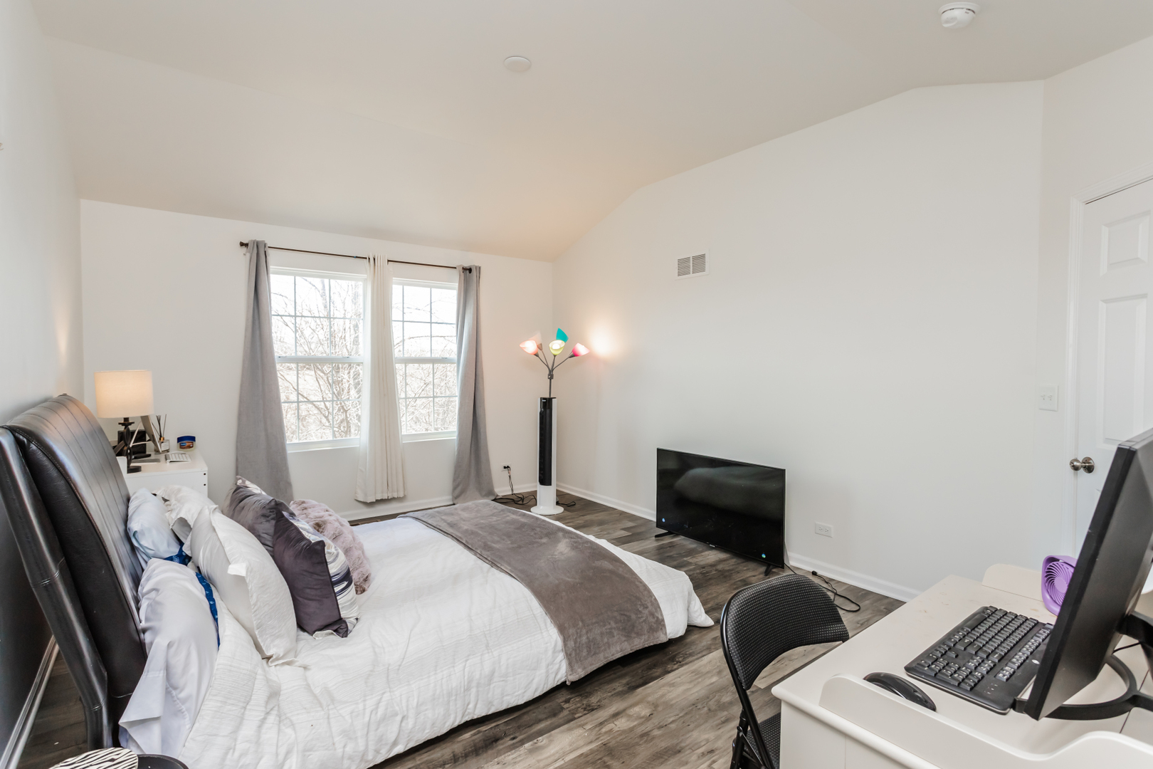 2928 Church Road Aurora, IL 60502 - Photo 18 of 29 a bedroom with a bed and a flat screen tv