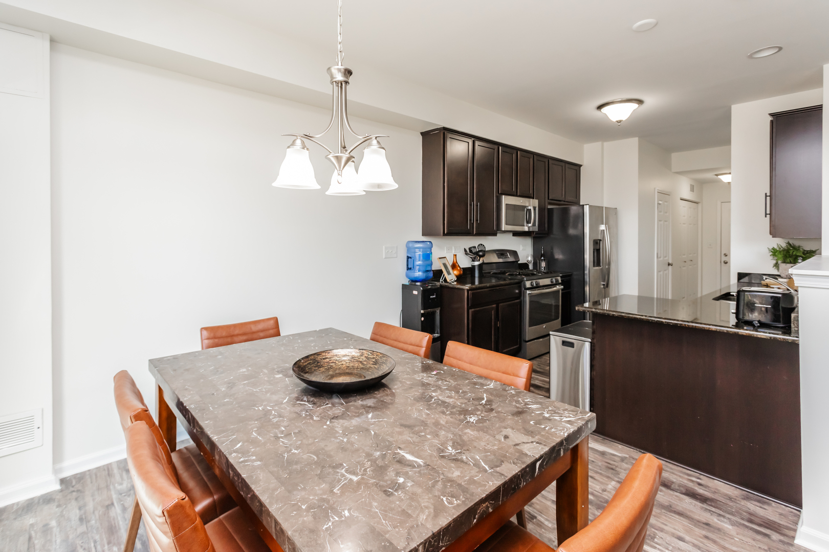 2928 Church Road Aurora, IL 60502 - Photo 8 of 29 a kitchen with stainless steel appliances granite countertop a table chairs and stove