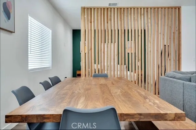 a living room with a wooden floor and furniture