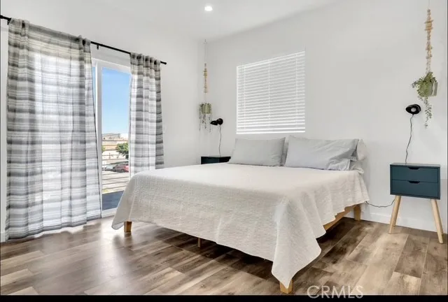 a large bed sitting in a bedroom next to a window