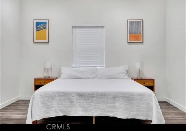 a bed sitting in a bedroom next to a window