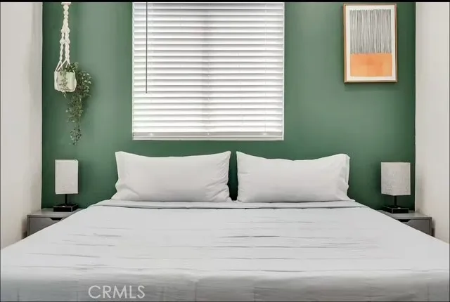 a bedroom with a bed and window