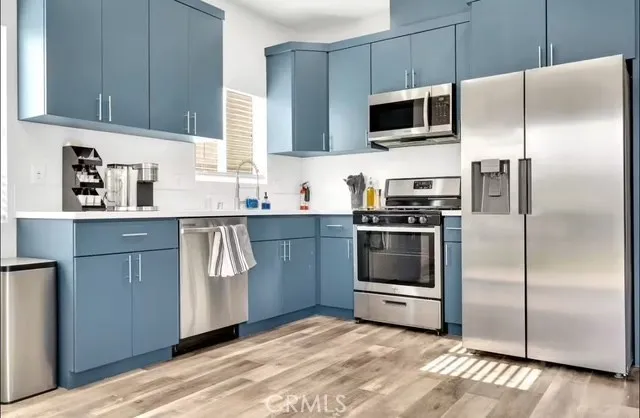 a kitchen with a refrigerator stove and microwave