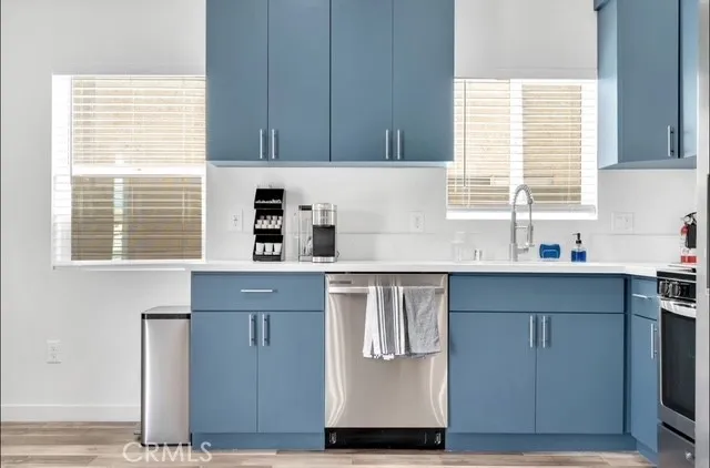 a kitchen with stainless steel appliances granite countertop a sink and a window