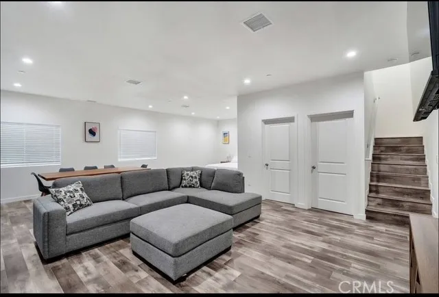 a living room with furniture and wooden floor