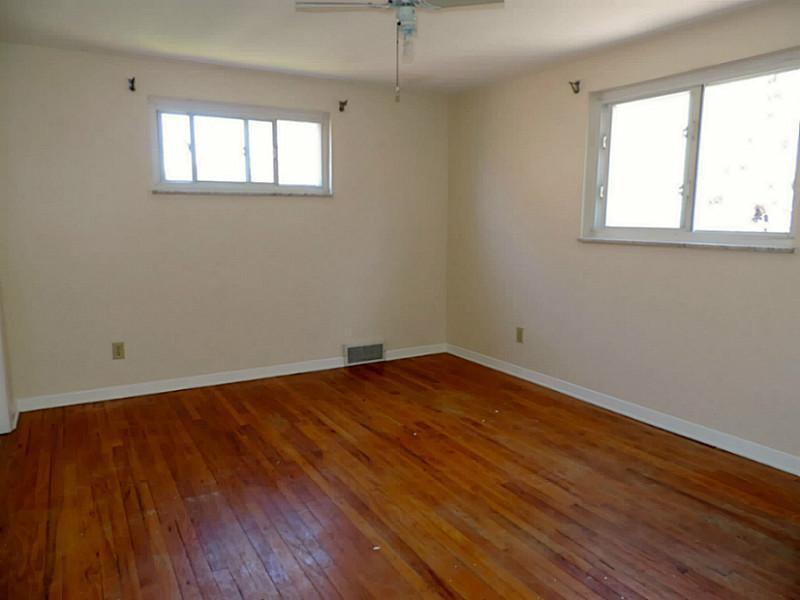 141 Techview Terrace Pittsburgh, PA 15213 - Photo 14 of 25 an empty room with wooden floor and windows