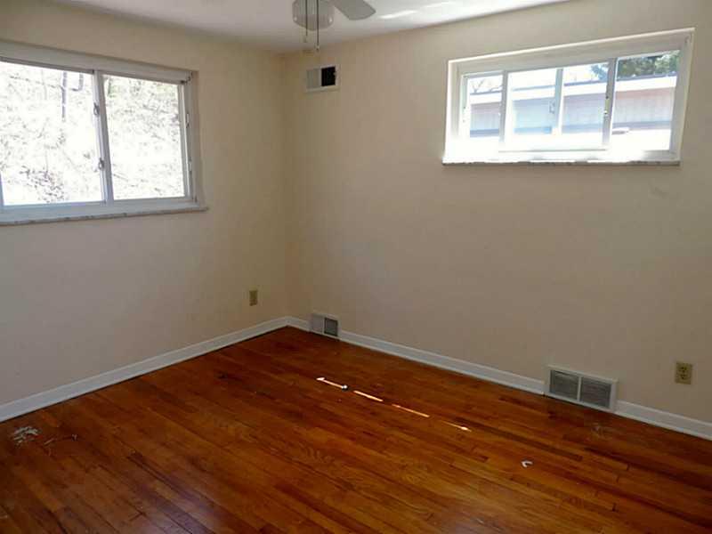 141 Techview Terrace Pittsburgh, PA 15213 - Photo 17 of 25 an empty room with wooden floor and windows