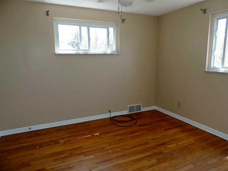 141 Techview Terrace Pittsburgh, PA 15213 - Photo 18 of 25 an empty room with wooden floor and windows