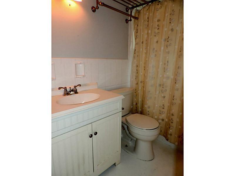 141 Techview Terrace Pittsburgh, PA 15213 - Photo 19 of 25 a bathroom with a sink a toilet and shower curtain