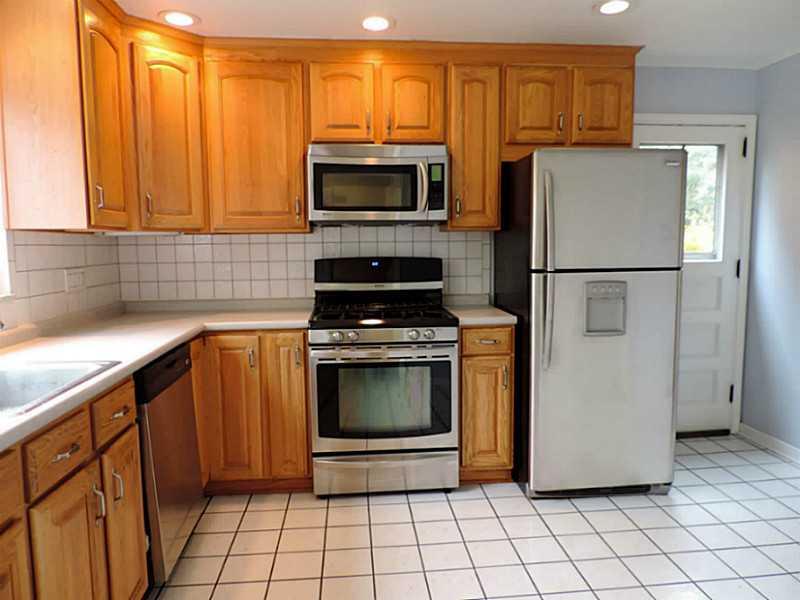 141 Techview Terrace Pittsburgh, PA 15213 - Photo 7 of 25 a kitchen with granite countertop a refrigerator and a stove top oven