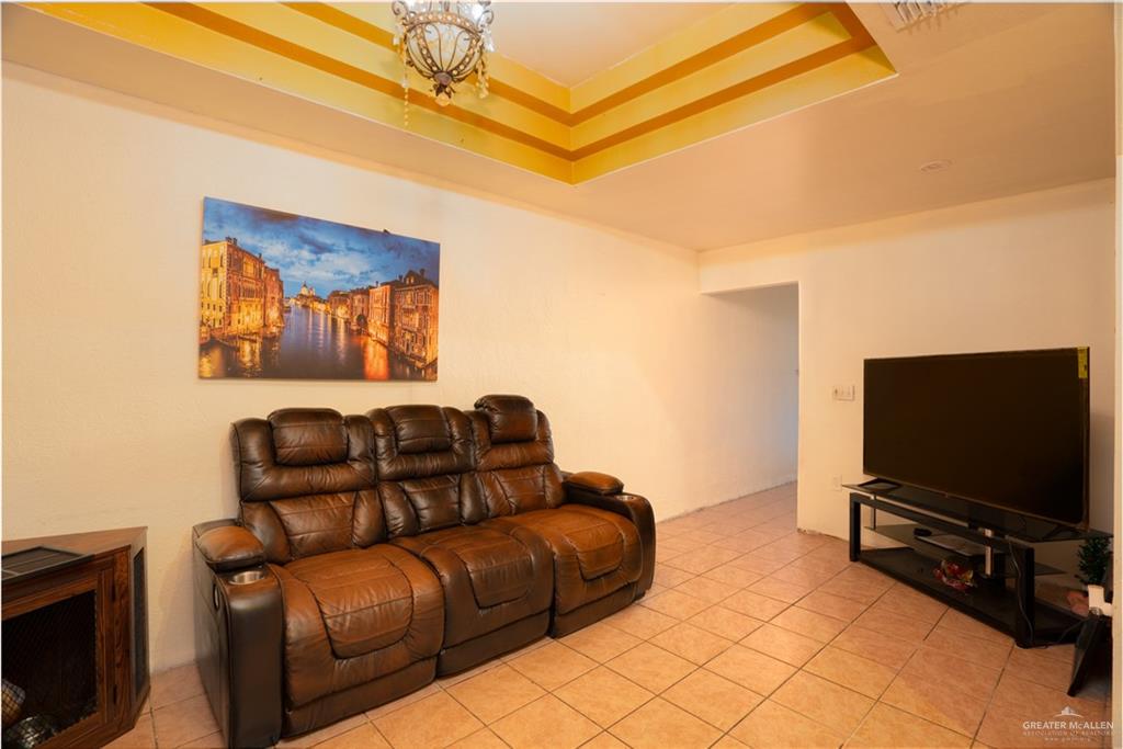 1608 Corales Street Mission, TX 78573 - Photo 25 of 29 a living room with furniture and a flat screen tv