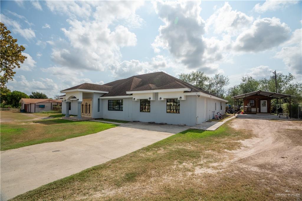 1608 Corales Street Mission, TX 78573 - Photo 6 of 29 a front view of a house with a yard