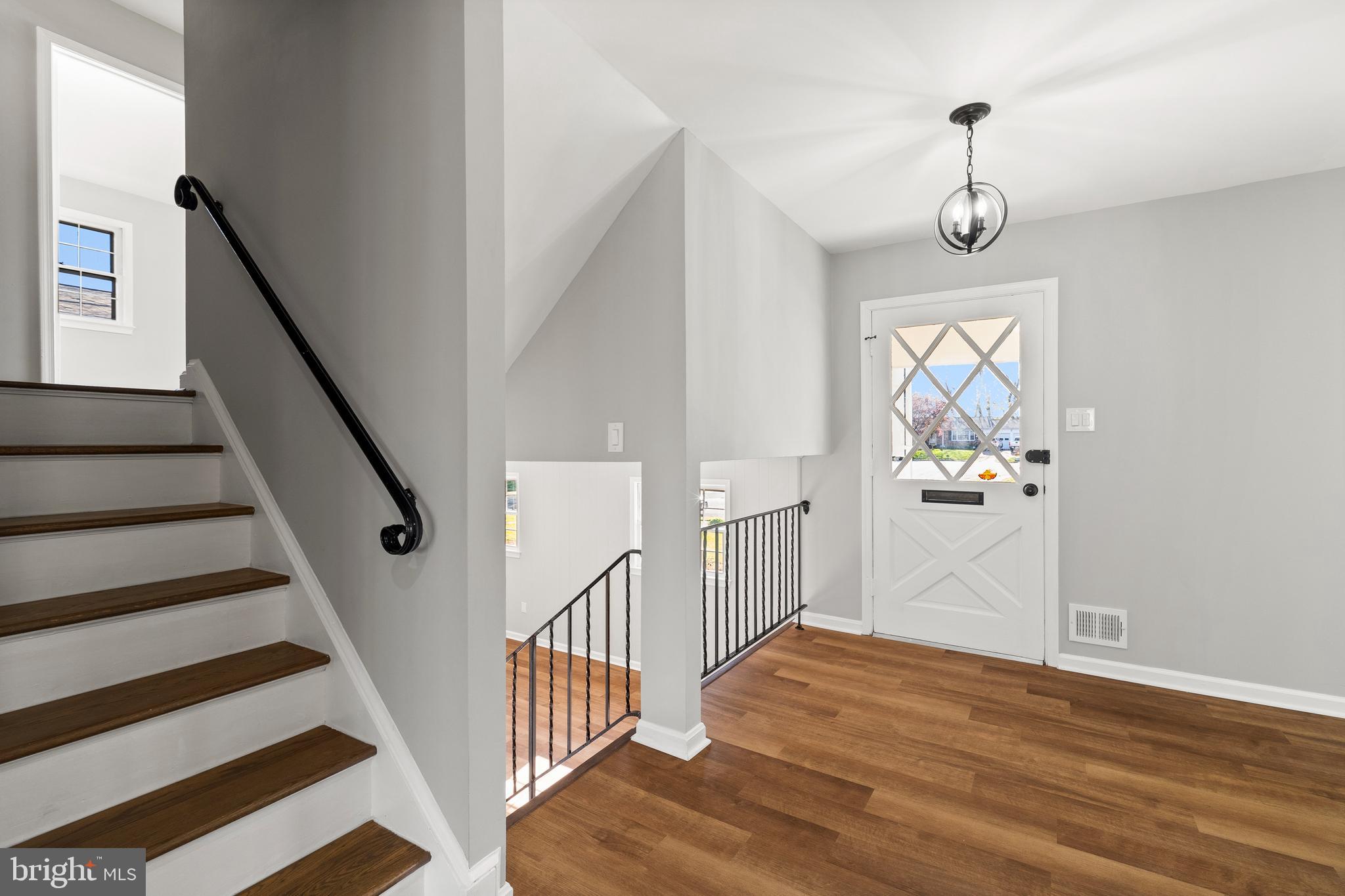 7517 Todd Place Manassas, VA 20109 - Photo 19 of 42 a view of a hallway with wooden floor and staircase