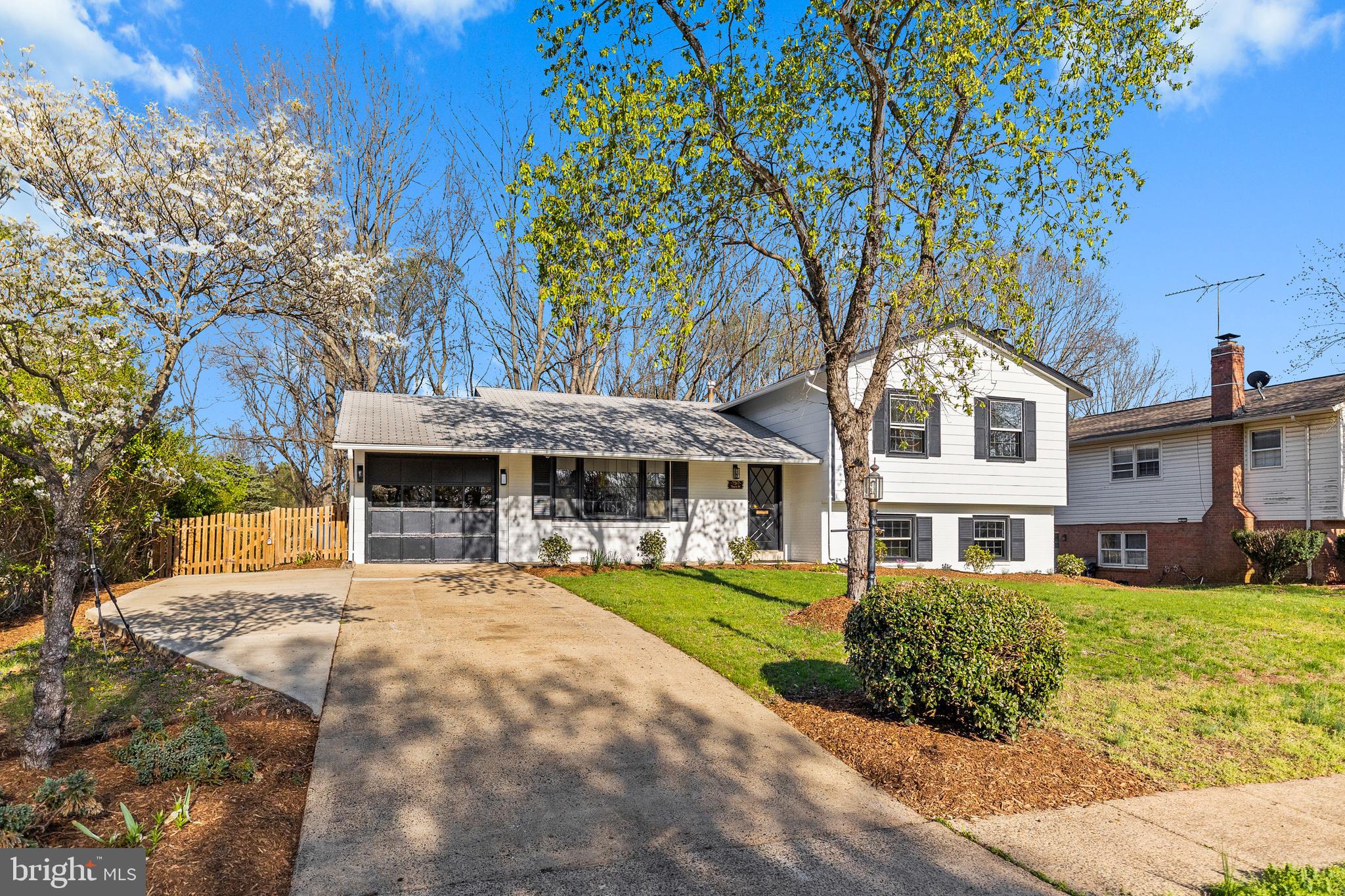 7517 Todd Place Manassas, VA 20109 - Photo 2 of 42 a front view of a building with a garden