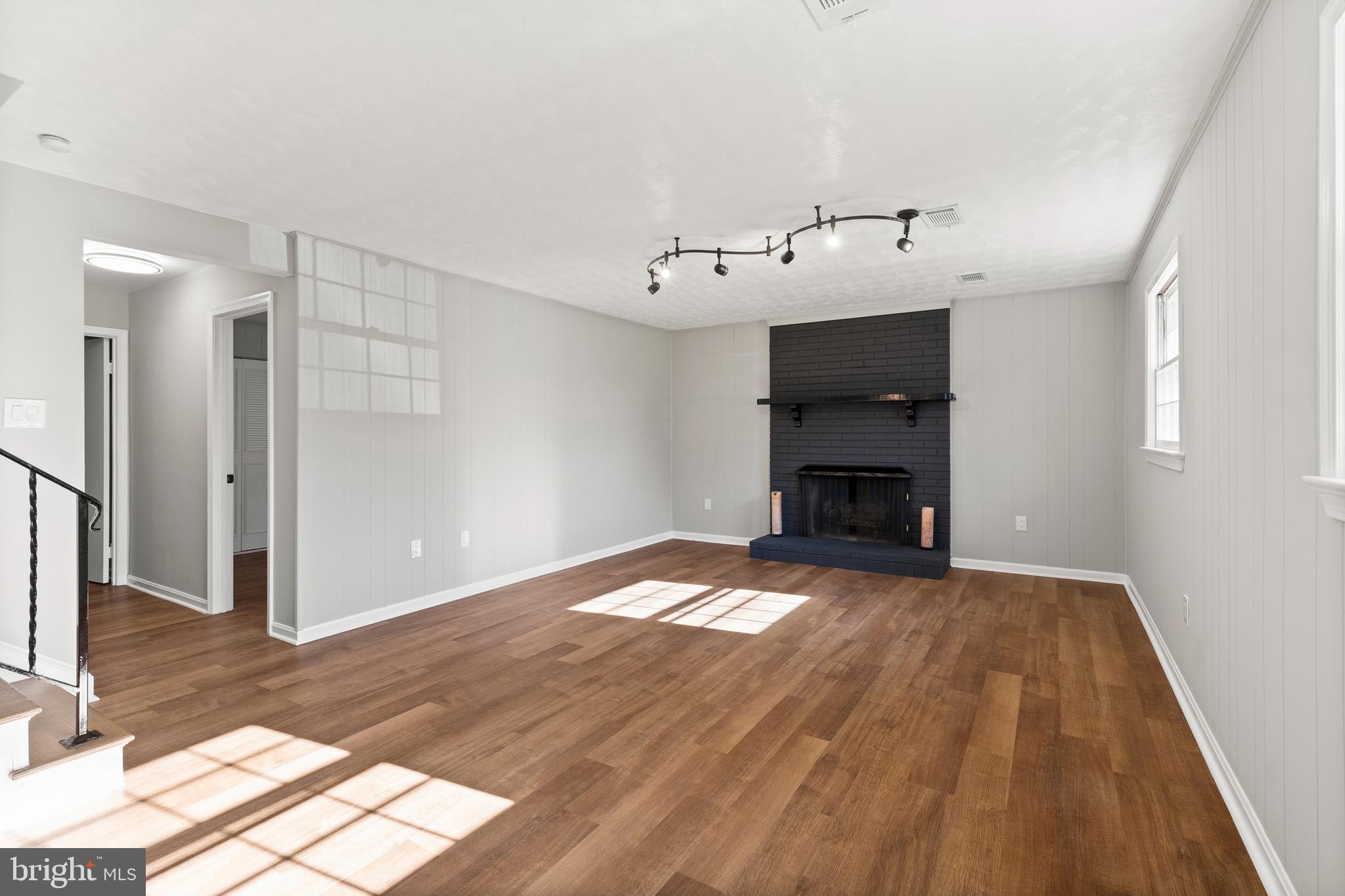 7517 Todd Place Manassas, VA 20109 - Photo 29 of 42 a view of empty room with wooden floor and fireplace