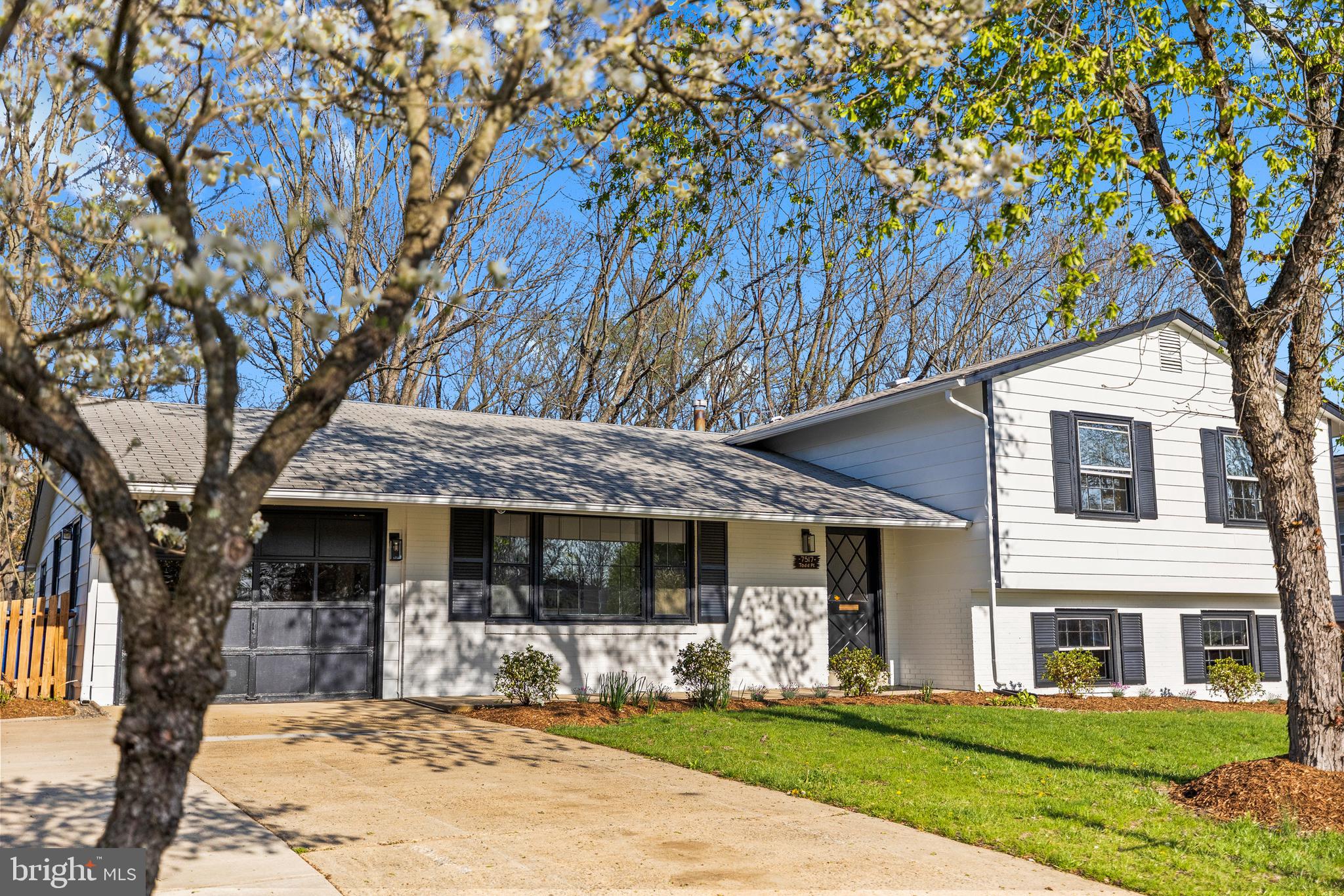 7517 Todd Place Manassas, VA 20109 - Photo 3 of 42 a front view of a house with a yard table and chairs