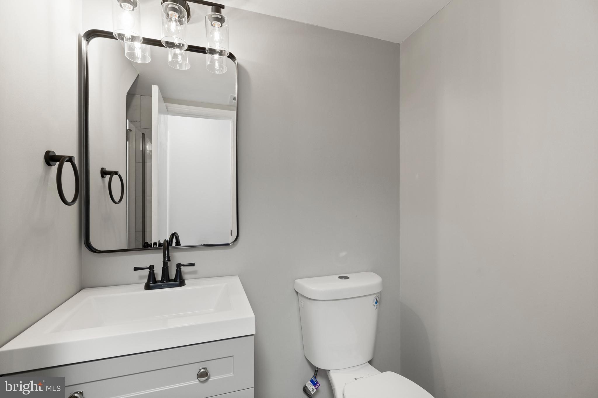 7517 Todd Place Manassas, VA 20109 - Photo 33 of 42 a bathroom with a sink a toilet and a mirror
