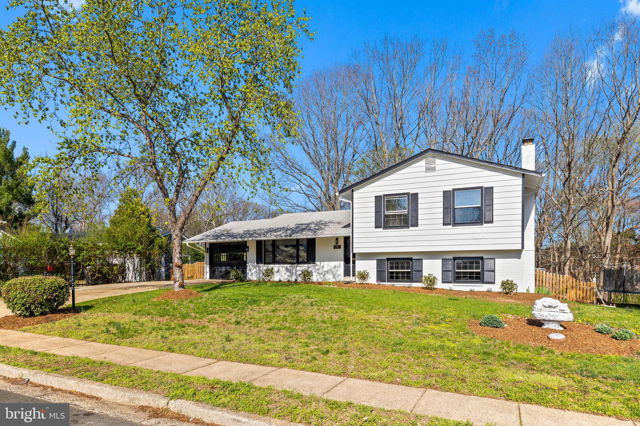 7517 Todd Place Manassas, VA 20109 - Photo 4 of 42 a front view of a house with a garden